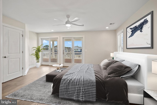 bedroom featuring access to exterior, light hardwood / wood-style floors, and ceiling fan