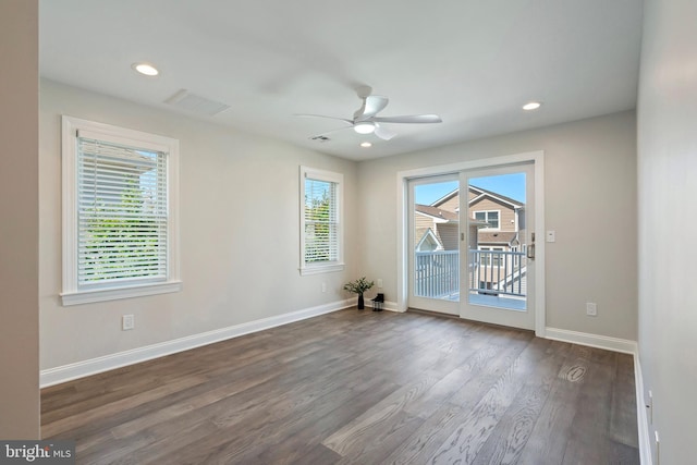 spare room featuring ceiling fan and dark hardwood / wood-style flooring