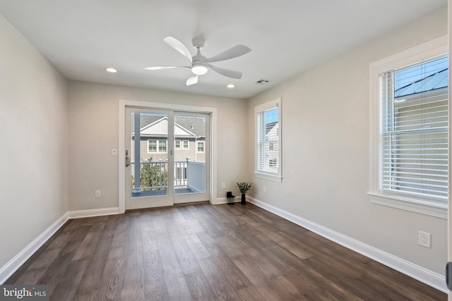 unfurnished room featuring dark hardwood / wood-style floors and ceiling fan