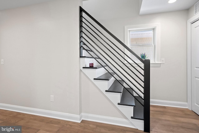 staircase featuring wood-type flooring