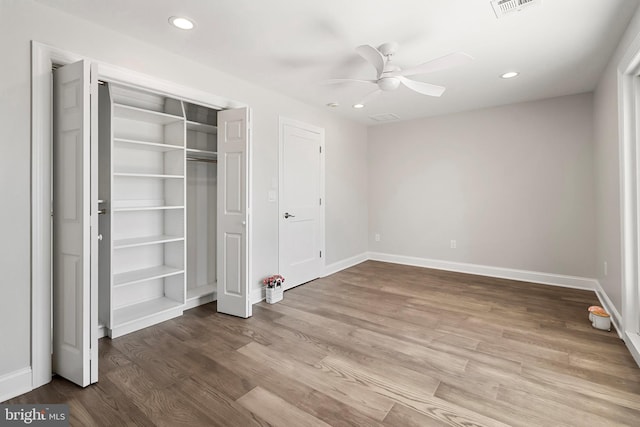 unfurnished bedroom featuring a closet, light hardwood / wood-style floors, and ceiling fan