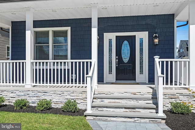 doorway to property featuring covered porch