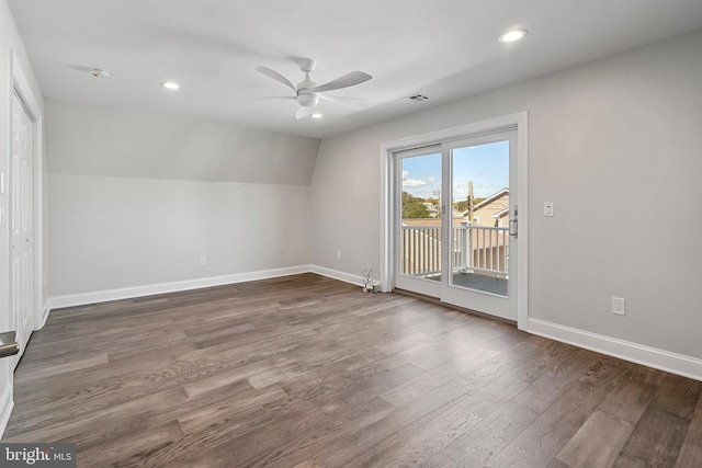 interior space with ceiling fan, dark wood-type flooring, and vaulted ceiling