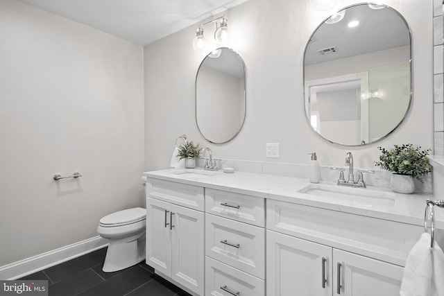 bathroom featuring tile patterned floors, vanity, and toilet