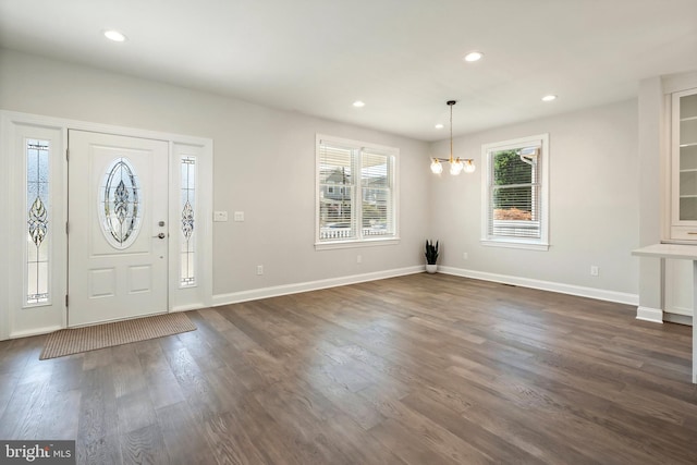 foyer entrance featuring a chandelier and dark hardwood / wood-style floors