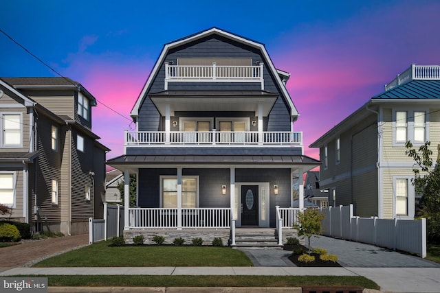 view of front of property with covered porch and a balcony