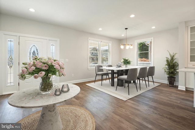 dining space featuring a chandelier and dark hardwood / wood-style floors