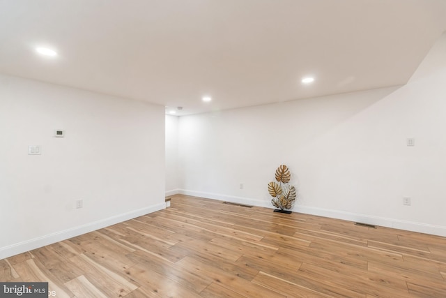 empty room with light hardwood / wood-style flooring