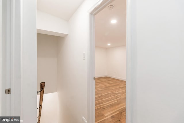 hallway with hardwood / wood-style floors