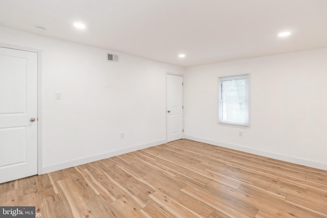 empty room with light hardwood / wood-style flooring