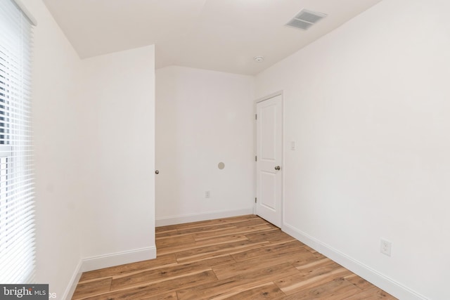 empty room with light hardwood / wood-style flooring and a healthy amount of sunlight