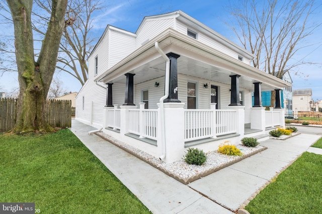 view of home's exterior with a porch and a yard