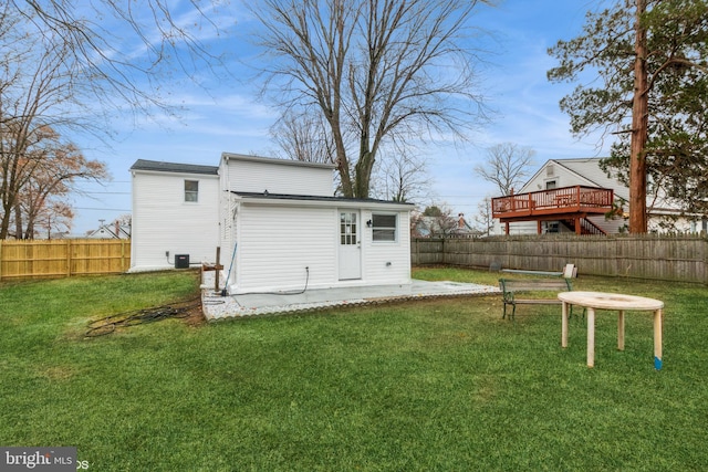 back of property with a patio area and a yard