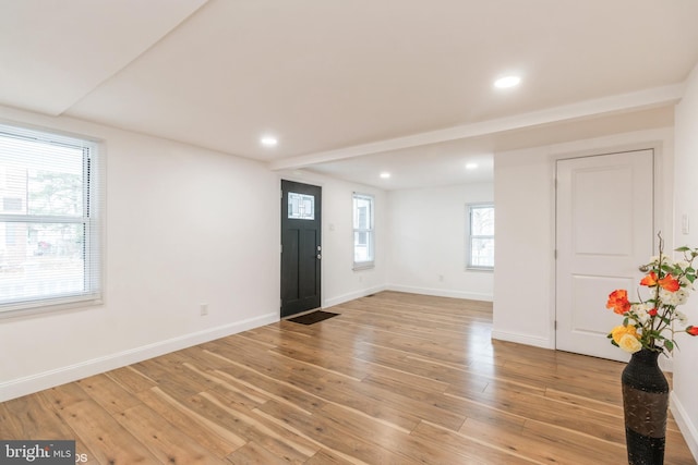 foyer entrance with light hardwood / wood-style flooring