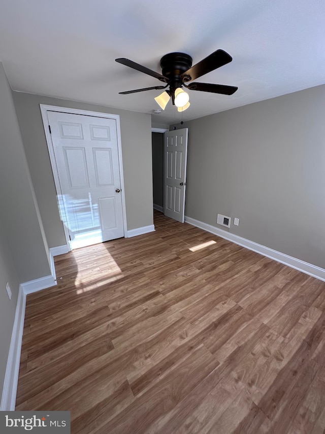 unfurnished bedroom featuring ceiling fan and wood-type flooring