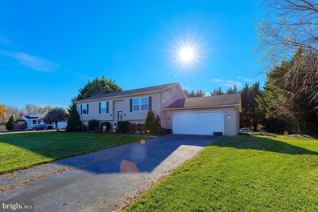 view of front of home featuring a front yard and a garage