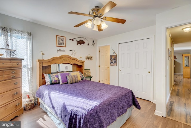 bedroom with ceiling fan, a closet, and light wood-type flooring