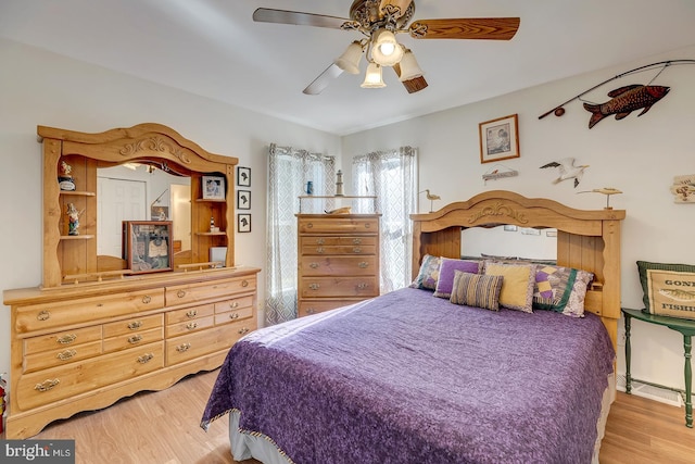 bedroom with ceiling fan and light hardwood / wood-style flooring