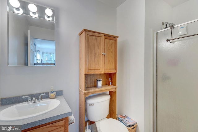 bathroom with vanity, toilet, and walk in shower