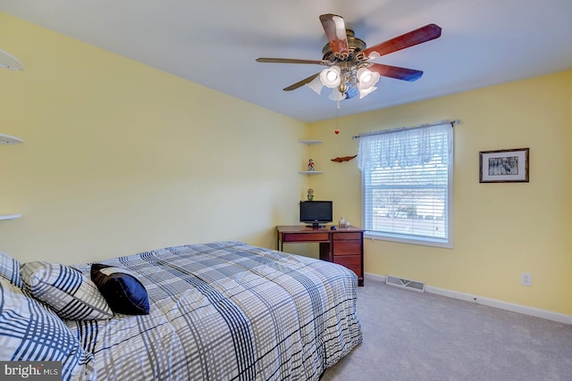 bedroom with ceiling fan and light carpet