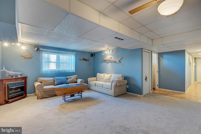 living room featuring carpet flooring, a paneled ceiling, and ceiling fan