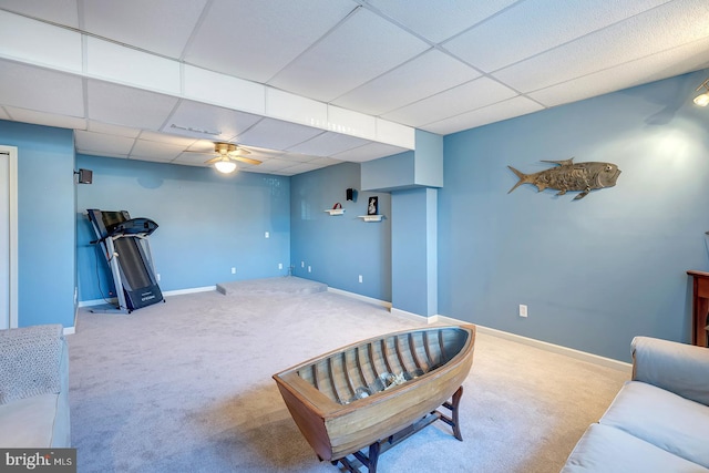 interior space featuring carpet, a paneled ceiling, and ceiling fan