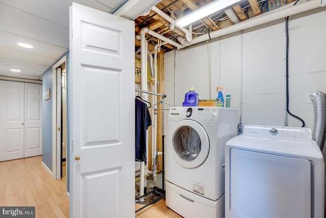 washroom featuring light wood-type flooring and separate washer and dryer