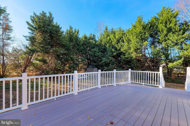 wooden terrace with a storage shed