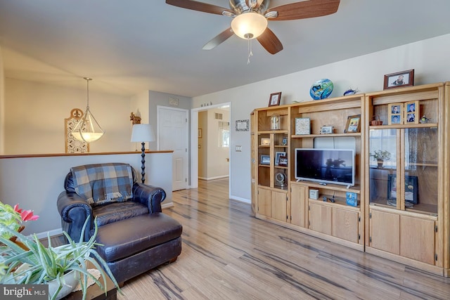 living room featuring ceiling fan and light wood-type flooring