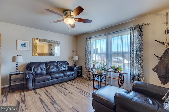 living room with ceiling fan and hardwood / wood-style flooring