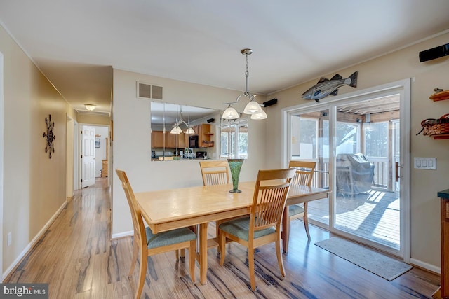 dining area featuring light wood-type flooring