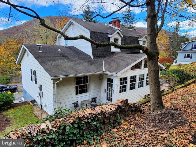 back of property featuring a mountain view