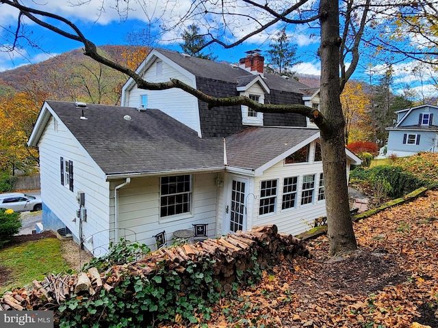 back of house with a mountain view