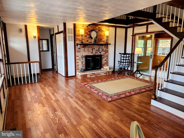 unfurnished living room featuring a fireplace and hardwood / wood-style floors