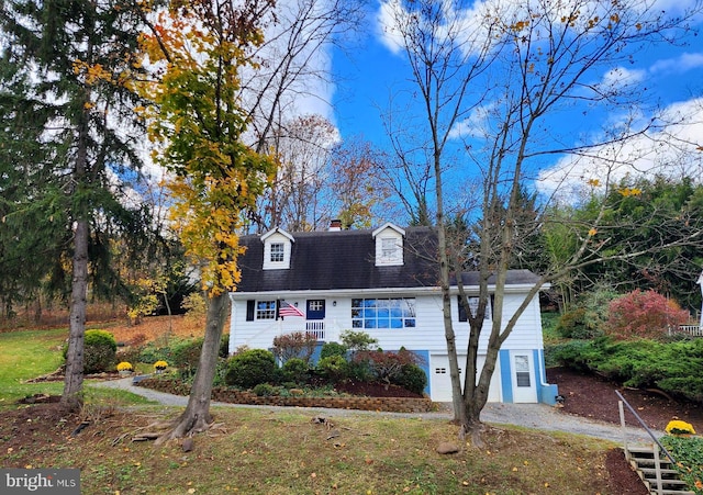 cape cod home with a garage