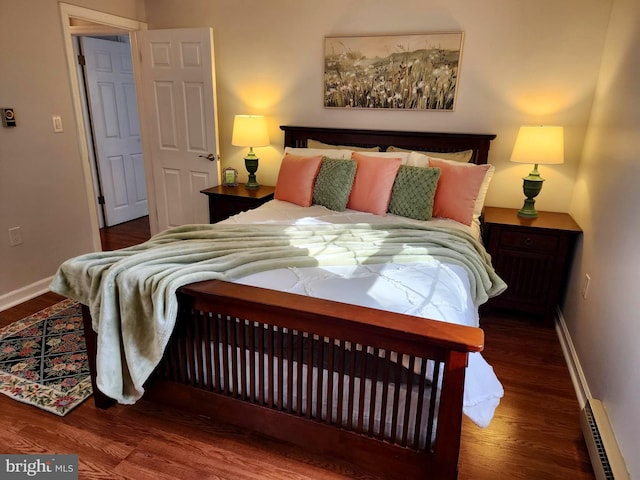 bedroom featuring dark hardwood / wood-style flooring and baseboard heating