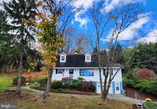 cape cod-style house with a garage