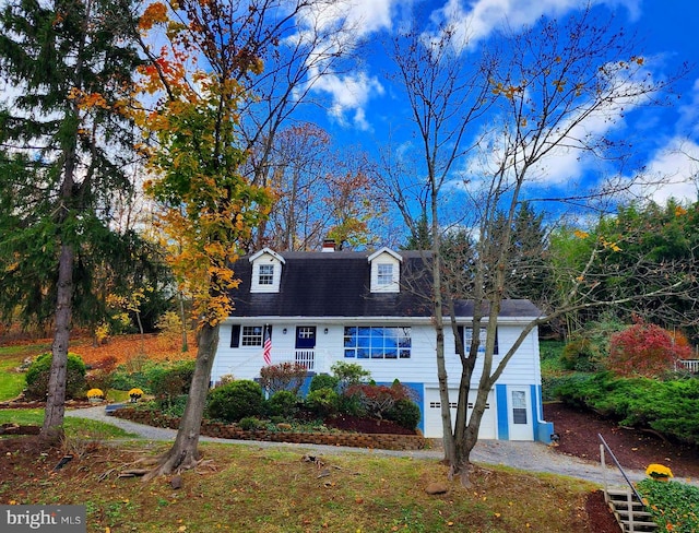 cape cod home featuring a garage