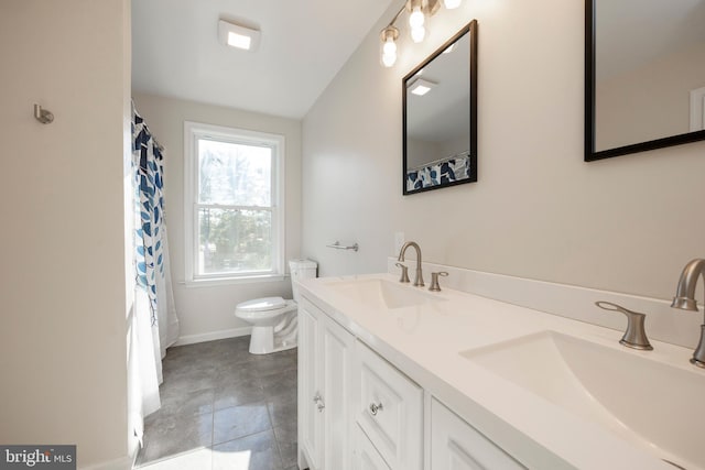 bathroom with tile patterned flooring, vanity, and toilet