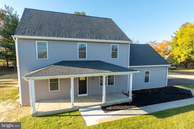 view of front of home featuring covered porch and a front lawn