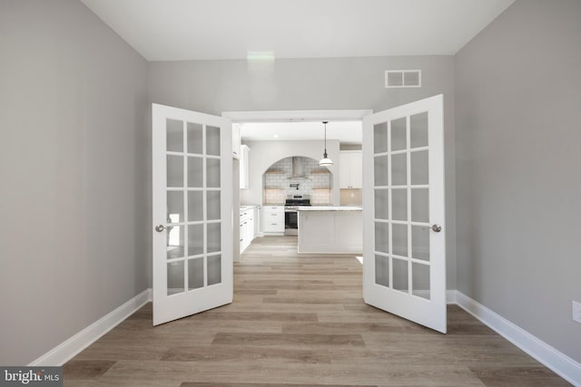 interior space featuring french doors and light wood-type flooring