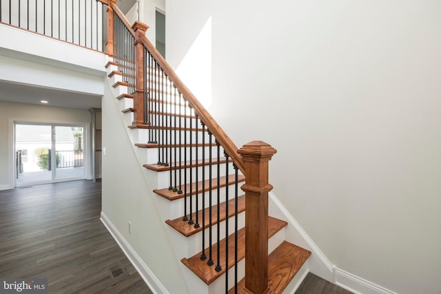 stairway featuring wood-type flooring