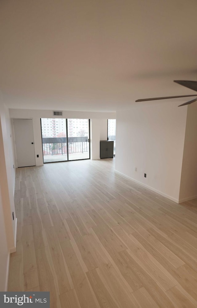 unfurnished living room with ceiling fan and light hardwood / wood-style floors