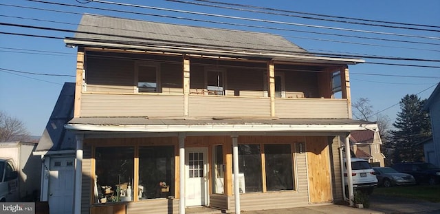 view of front of home with a balcony and covered porch