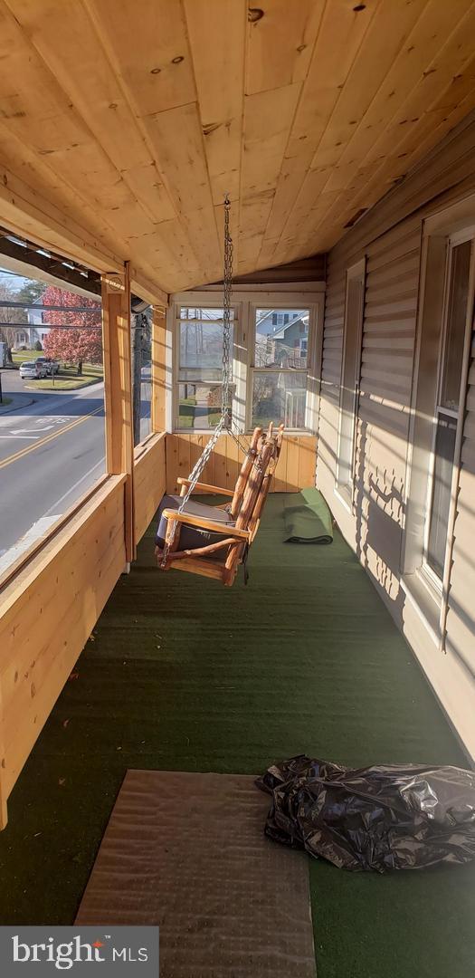 unfurnished sunroom featuring wooden ceiling