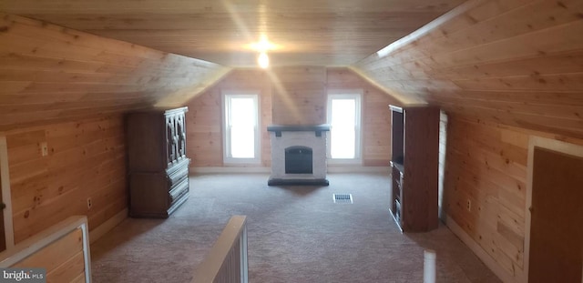 bonus room featuring wood walls, light colored carpet, lofted ceiling, and wooden ceiling