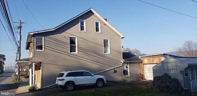 rear view of house featuring a garage