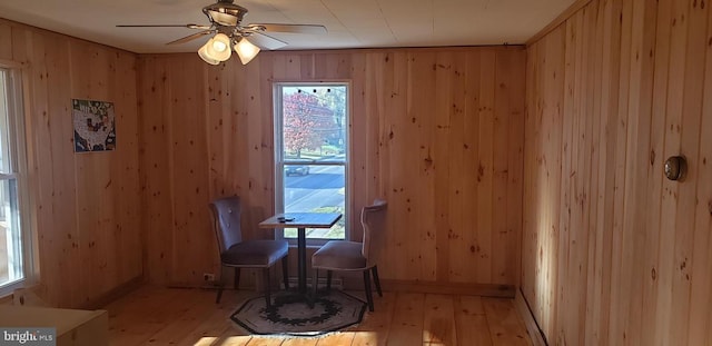 3827 W Main St, Belleville, PA 17004 - dining area featuring light wood-style flooring, wood walls, and a ceiling fan