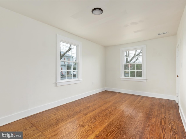 unfurnished room with wood-type flooring