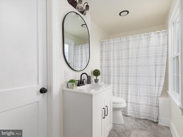 full bathroom with vanity, shower / bath combination with curtain, and toilet